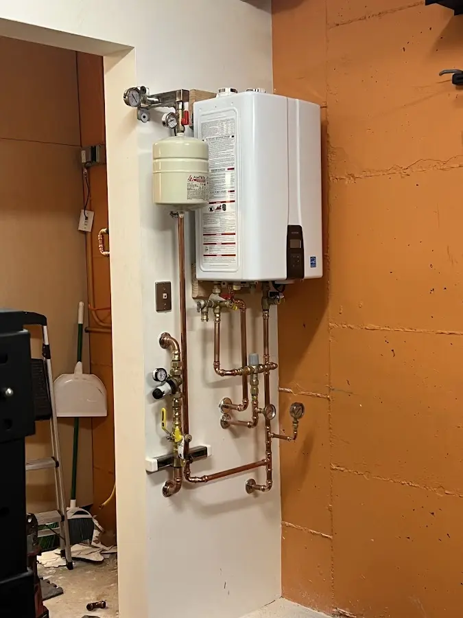Plumbing technician inspecting water heater connections in Washoe Valley